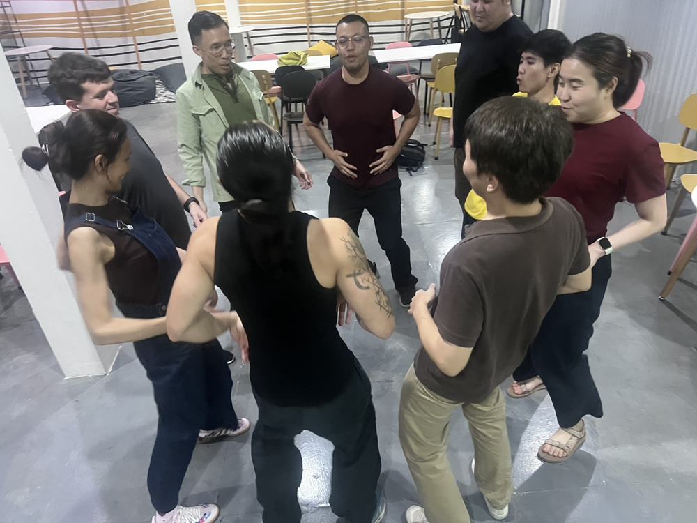 The group playing a game in a circle