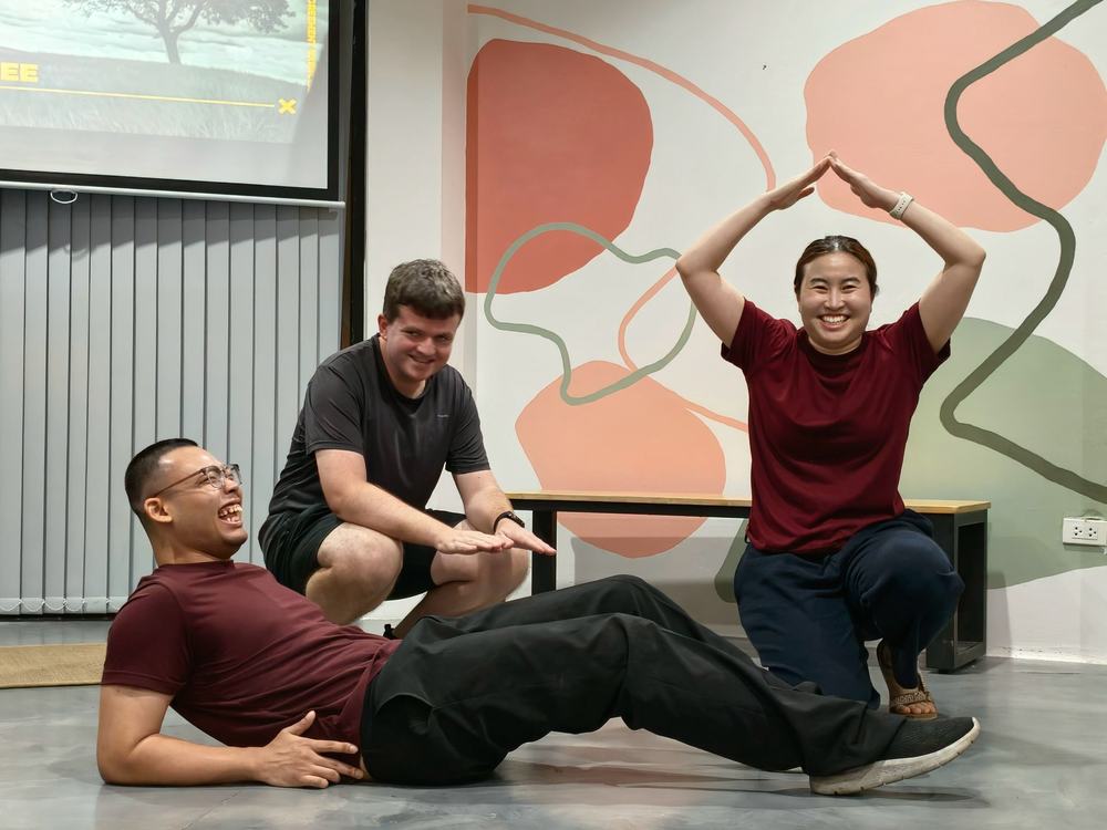 Three participants striking a group pose